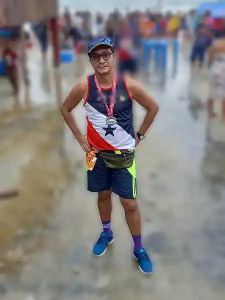 Mauricio Bezerra de Sousa com a medalha na praia, após a Meia Maratona do Atlântico em Salinópolis, 2021